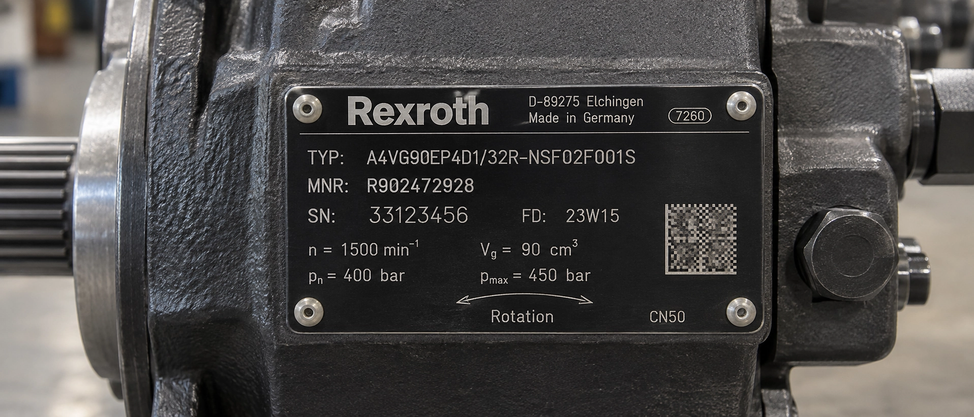 Close-up of an axial piston hydraulic pump nameplate showing the type code, material number and serial number used to match an original vs aftermarket replacement pump configuration Close-up of an axial piston hydraulic pump nameplate showing the type code, material number and serial number used to match an original vs aftermarket replacement pump configuration